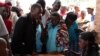 FILE - Burundian refugees register with officials at a Bugesera reception to enter Eastern Rwanda. (M.Yusuf/VOA)
