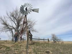FILE - Rancher L.J. Turner stands near a well on his spread south of Gillette, Wyo., March 29, 2017. Many locals say they're optimistic President Donald Trump will revitalize the coal industry. Economists and Turner are skeptical.