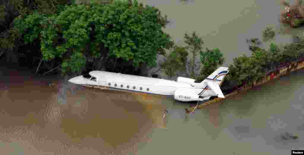 An aerial view of a partially submerged airplane in a flood area in Chennai, India