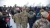 Members of the group occupying the Malheur National Wildlife Refuge headquarters hug after Ammon Bundy, center, left, one of the sons of Nevada rancher Cliven Bundy, spoke with reporters during a news conference Monday, Jan. 4, 2016, near Burns, Oregon.