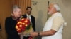Chief Minister of the western Indian state of Gujarat and Bharatiya Janata Party (BJP) prime ministerial candidate Narendra Modi (R) presents a bouquet of flowers to US Ambassador to India Nancy Powell (L) as they meet in Gandhinagar in western Gujarat st