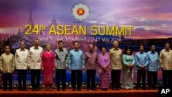 Leaders of Association of Southeast Asian Nations pose for a photograph ahead of a dinner hosted by Myanmar President Thein Sein during the 24th ASEAN Summit in Naypyitaw, Myanmar, Saturday, May 10 2014. Leaders from left, Laos President Choummaly Sayaso