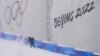 A worker shovels snow in preparation for freestyle ski and snowboard events at Genting Snow Park prior to the 2022 Winter Olympics, in Zhangjiakou, China, Jan. 31, 2022.