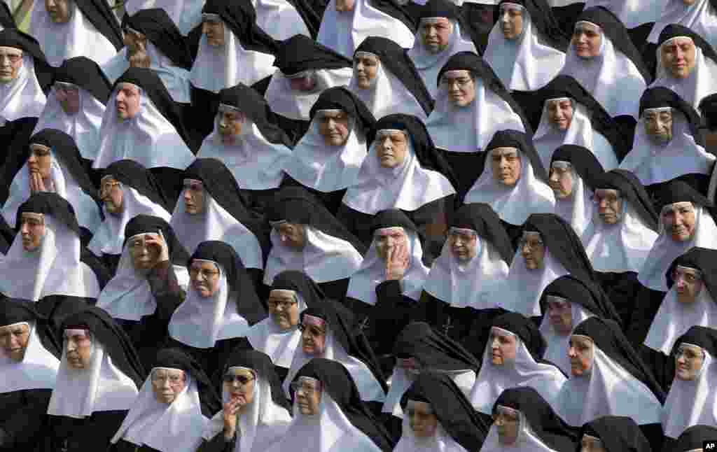Nuns pray during a canonization ceremony in St. Peter's Square at the Vatican. Pope Francis canonized the Catholic Church's first married couple in modern times, declaring the parents of the beloved St. Therese of Lisieux saints in their own right.