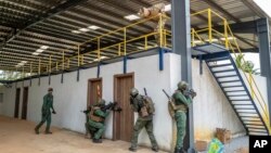 FILE - Ivorian soldiers conduct an urban reconnaissance exercise under the supervision of French special forces at Camp Loumbila, Jacqueville, Ivory Coast, on Feb. 16, 2022. Ivory Coast said on Dec. 31, 2024, that French troops will leave the country in the next month.