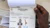 Uganda presidential elections ballot paper is held by election worker at a polling station in Rukungiri about 319 kilometers (199 miles) west of Uganda capital Kampala Friday Feb. 18, 2011. Uganda's long-serving president says he will not become the late