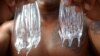 Curtis Cuba, working his fourth year as an ocean safety officer (lifeguard) in Hawaii, holds up two box jellyfish, July 22, 2003, on Waikiki Beach. Box jellyfish are one of the most dangerous marine animals in Australia’s waters.