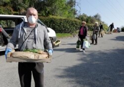 Local residents practice social distancing as they shop fruits and vegetable directly from "Le potager de Saquier" farm in Nice, France, as a lockdown is imposed to slow the rate of the coronavirus, April 3, 2020.