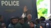 Salahuddin Quader Chowdhury, a senior opposition leader, waves to the media after he arrives at the war crime tribunal, in Dhaka, Bangladesh, Oct. 1, 2013.