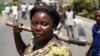 A female protester holds an ax during a protest against Burundian President Pierre Nkurunziza's decision to run for a third term in Bujumbura, Burundi, May 13, 2015.