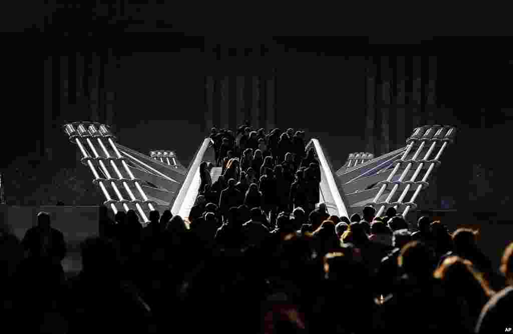 Pedestrians stroll over the Millenium bridge in London.