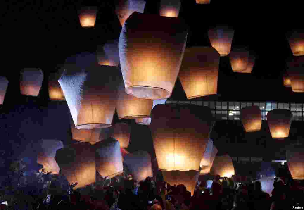 People release sky lanterns ahead of the traditional Chinese Lantern Festival in Pingxi, New Taipei City, Taiwan.