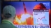 A man watches a TV screen showing a file image of North Korea's missile launch during a news program at the Seoul Railway Station in Seoul, South Korea, Sunday, March 29, 2020. 
