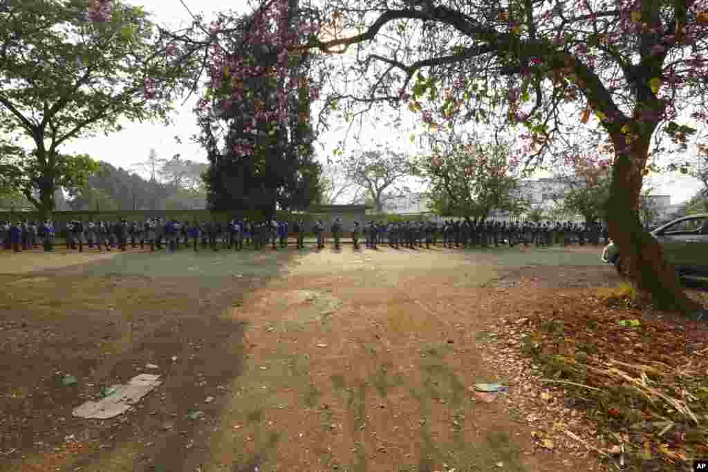 Schoolchildren queue outside their school in Harare, Zimbabwe.