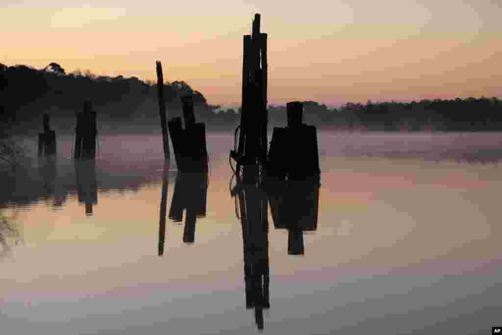 Fog drifts over the still waters of the North Santee River as the sun rises in Georgetown, South Carolina.