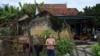 A Vietnamese woman stands outside her house in Yen Thanh district of Vietnam's Nghe An province, Oct. 27, 2019.