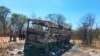 Emergency services stand near to a burned out bus after a bus accident in Gwanda about 550 kilometres south of the capital Harare, Nov. 16, 2018. Police in Zimbabwe say more than 40 people have been killed in a bus accident Thursday night.