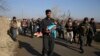 An Afghan Security police carries his injured daughter after an attack near the Bagram Air Base In Parwan province of Kabul, Afghanistan, Wednesday, Dec. 11, 2019.