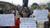 FILE - Protesters march who are against Burundi President Pierre Nkurunziza and his bid for a third term, in Bujumbura, Burundi, June 4, 2015.