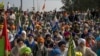 Protesting farmers listen to a leader speak after they were stopped by the police near Shambhu border that divides northern Punjab and Haryana states, almost 200 kilometers (125 miles) from New Delhi, India, Feb.16, 2024. 
