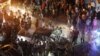 People are seen gathered at the site of a car bomb blast in Azaz, Syria, June 2, 2019.