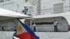 American crew members stand on the deck of the decommissioned U.S. Coast Guard cutter Dallas in North Charleston S.C., on May 22, 2012, during a ceremony in which it was transferred to the Philippine Navy.