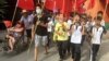Villagers including schoolchildren take part in a protest march, demanding the release of their village chief Lin Zuluan, in Wukan, in China's Guangdong province, June 21, 2016. 