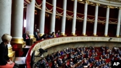FILE - Visitors, top, and parliament members attend the questions to the government session at the National Assembly in Paris, Dec. 4, 2018