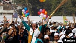 A supporter of Aam Aadmi (Common Man) Party (AAP) cheers after its leader Arvind Kejriwal took an oath as the new chief minister of Delhi during a swearing-in ceremony at Ramlila ground in New Delhi, Dec. 28, 2013. 