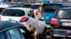 Young people react during the drive-in Easter service at the parking lot at Aalborg Airport, Denmark, April 12, 2020, amid the spread of the novel coronavirus COVID-19.