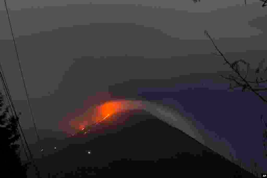 The Pacaya volcano spews lava, viewed from San Vicente Pacaya, Guatemala.