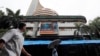 A man looks at the display screen on the facade of the Bombay stock exchange (BSE) in Mumbai, India, July 10, 2014. 