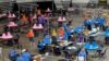 FILE - Maricopa county ballots cast in the 2020 election are examined and recounted by contractors working for Florida-based company Cyber Ninjas at Veterans Memorial Coliseum in Phoenix, Arizona, May 6, 2021.