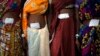 Women who underwent surgery at a government mass sterilization camp pose for pictures inside hospital, Bilaspur district in the eastern Indian state of Chhattisgarh, India, Nov. 14, 2014.