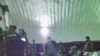 FILE - Prisoners freed from Taliban prisons in Helmand dine at an Afghan military facility. 