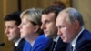 Ukraine's President Volodymyr Zelenskiy, German Chancellor Angela Merkel, French President Emmanuel Macron and Russia's President Vladimir Putin attend a joint news conference after a summit in Paris, Dec. 9, 2019.