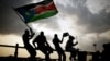 Southern Sudanese wave flags and cheer at the Republic of South Sudan's first national soccer match in the capital of Juba, July 10, 2011. 