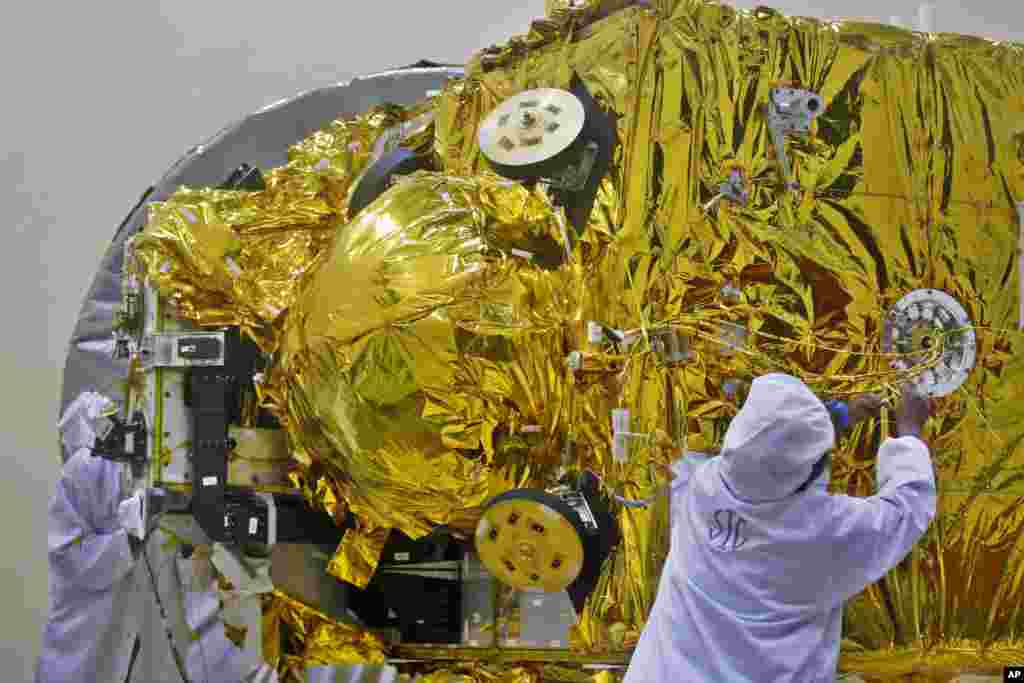 Indian engineers work on the Mars orbiter spacecraft at the satellite center of Indian Space Research Organization in Bangalore. India&rsquo;s ambitious US $71,096,000 Mars orbiter mission is scheduled to be launched by Polar Satellite Launch Vehicle between Oct. 21 and Nov. 19, 2013 from Sriharikota in south India, project director Arunan. S said.