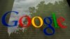 FILE - The Google logo on a window at the company's headquarters in Mountain View, Calif. 