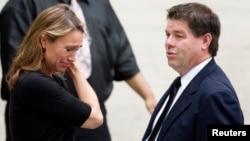 A mourner weeps outside the funeral services of James Gandolfini at the Cathedral Church of Saint John the Divine in New York, June 27, 2013.