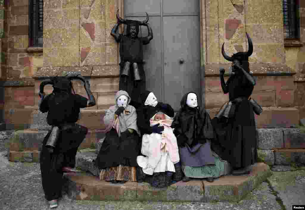 Revelers, dressed as &quot;Diablos de Luzon&quot; (Luzon Devils), and others dressed as &quot;Mascaritas&quot; pose during carnival celebrations in the village of Luzon, Spain, Feb. 6, 2016.