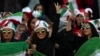 An Iranian woman flashes a victory sign during a soccer match between Iran and Cambodia in the 2022 World Cup qualifier at the Azadi (Freedom) Stadium in Tehran, Iran, Oct. 10, 2019. Iranian women were allowed into the stadium for the first time in years.