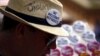 FILE - A man sells badges to demonstrators during a rally in support of refugees that was part of a national campaign in central Sydney, Australia, Oct. 11, 2015.