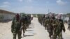 FILE - Members of Somalia's al-Shabab militant group patrol on the outskirts of Mogadishu, March, 5, 2012. 