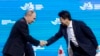 Russia's President Vladimir Putin, left, shakes hands with Japan's Prime Minister Shinzo Abe at a plenary session titled "The Russian Far East: Creating a New Reality" at the 2017 Eastern Economic Forum in Vladivostok, Russia, Sept. 7, 2017. 