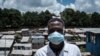 A staff member of local NGO Shining Hope for Communities wears a face mask as a preventive measure against the COVID-19 coronavirus as the NGO installs hand-washing stations at the Kibera slum in Nairobi, March 18, 2020. 
