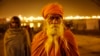 A Hindu holy man stands at Sangam, the confluence of the rivers Ganges, Yamuna and the mythical Saraswati during the annual traditional fair of Magh Mela, in Allahabad, India, Feb. 14, 2014.