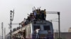 Passengers travel on an overcrowded train on the outskirts of New Delhi February 26, 2015. India will increase investment in its overloaded railway network to 8.5 trillion rupees ($137 billion) over the next five years.