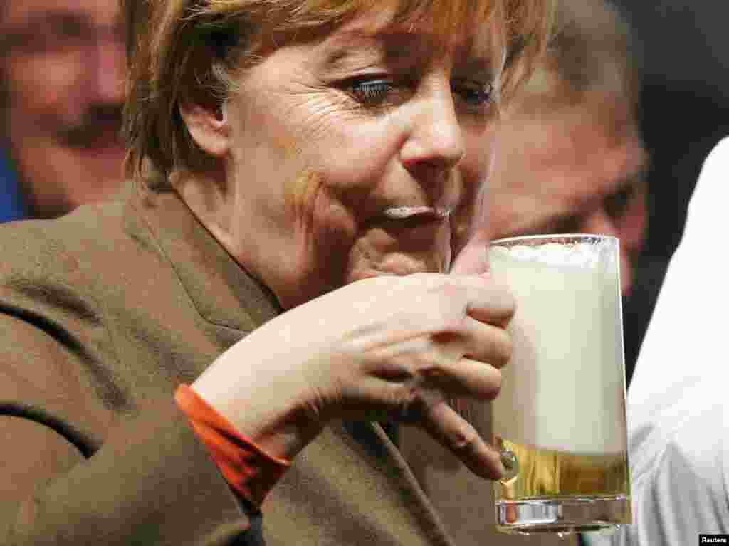German Chancellor Angela Merkel enjoys a beer during the Christain Democratic Union (CDU) politial Ash Wednesday meeting in Volkmarsen.