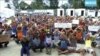 FILE - In this file photo made from Australia Broadcasting Corporation video taken shows asylum seekers protesting the possible closure of their detention center on Manus Island, Papua New Guinea, Oct. 31, 2017.